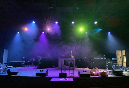 Stage with fog with green, purple and orange lights