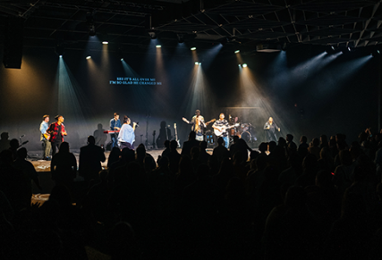Church band on stage with audience silhouette