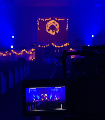 Blue-lit church with golden orange lights on the altar