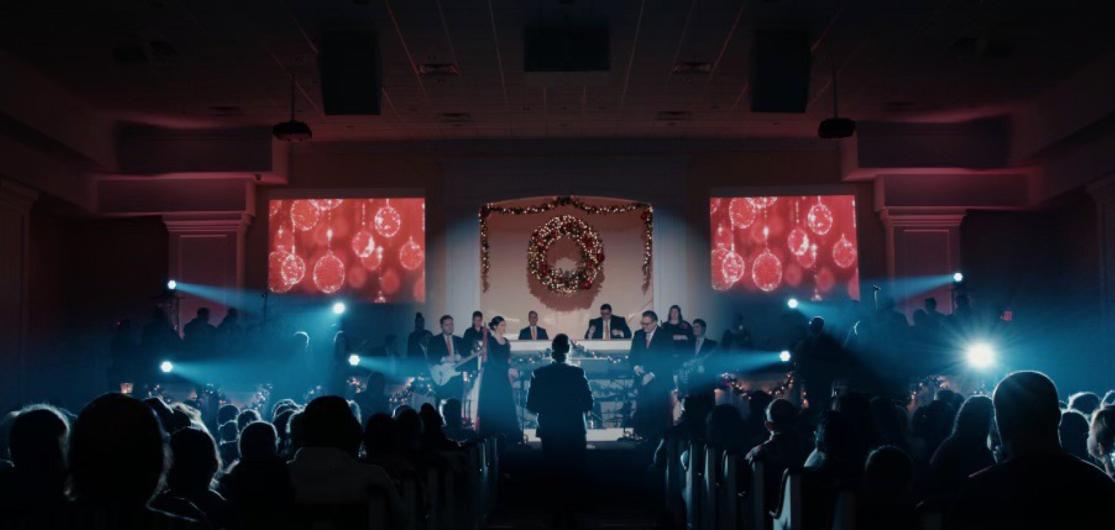 Church altar with white light beams and wreath center stage