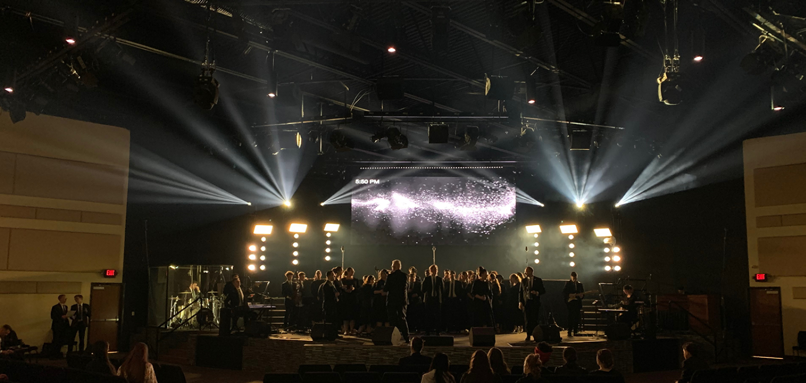 White and gold lit stage with sparks on backscreen