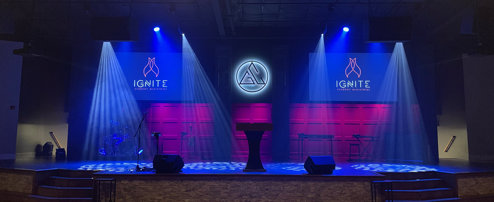 Stage with blue light beams and purple backlighting